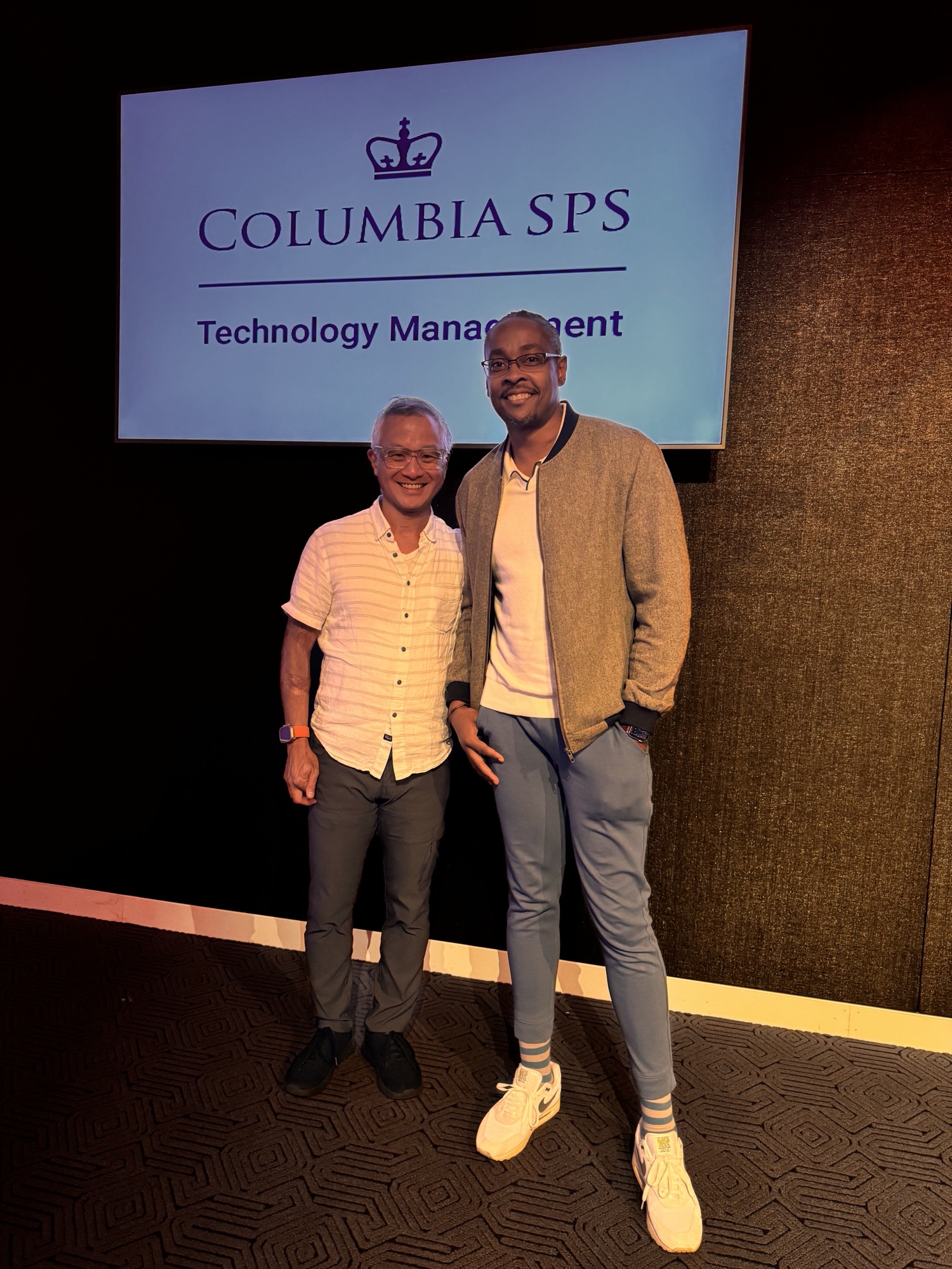 Kenan with a colleague in front of the Columbia SPS Technology Management welcome screen