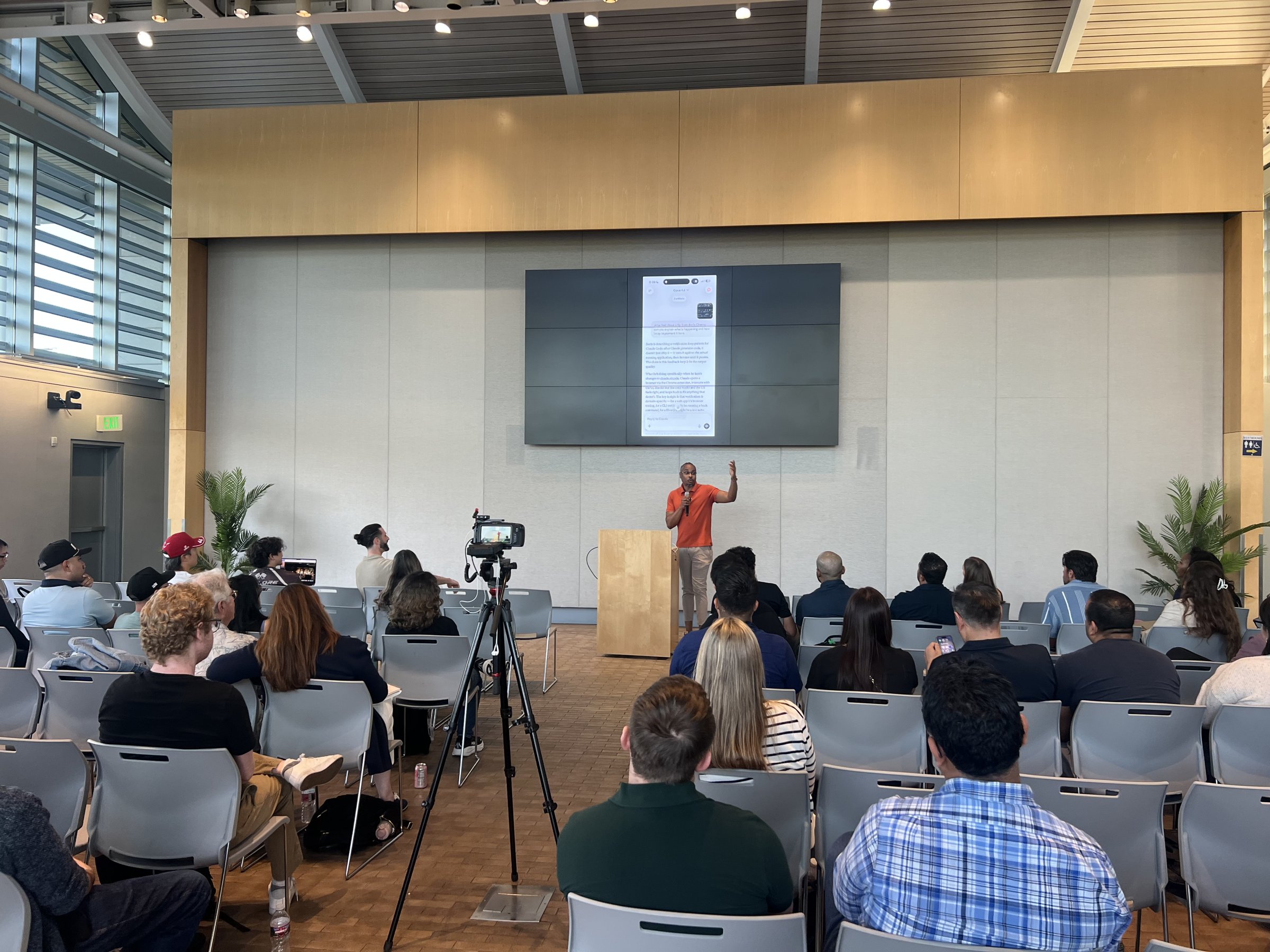 Wide view of Kenan presenting to a full conference room
